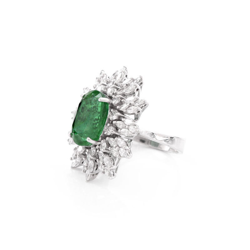 Approx. 5.30 Carat Oval Cut Emerald, 1.95 Carat TW Marquise and Round Brilliant Cut Diamond and 18 Karat White Gold Ring.