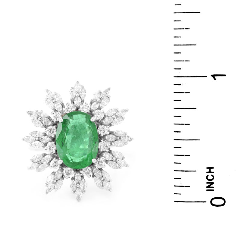 Approx. 5.30 Carat Oval Cut Emerald, 1.95 Carat TW Marquise and Round Brilliant Cut Diamond and 18 Karat White Gold Ring.