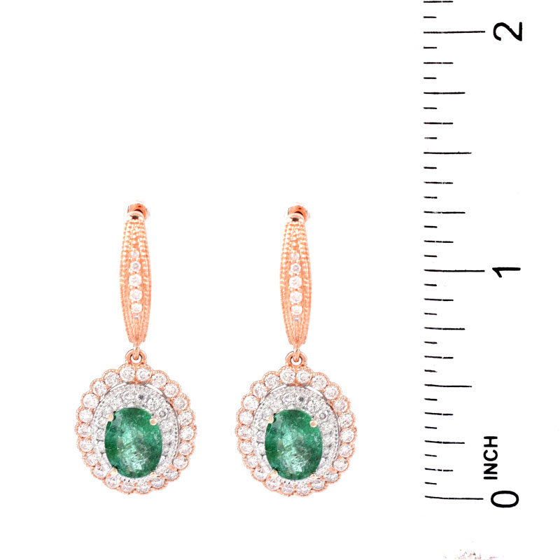 Pair of Oval Cut Colombian Emerald, Round Brilliant Cut Diamond and 14 Karat Rose Gold Pendant earrings, Emeralds with vivid color. 