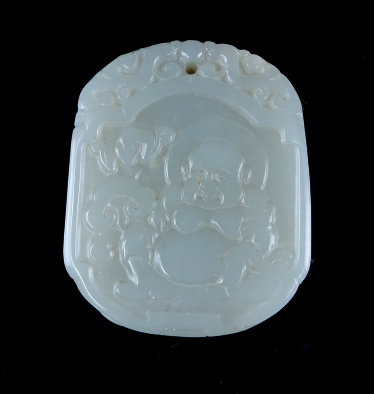 A Chinese Carved Celadon Jade Pendant with Buddha Relief.