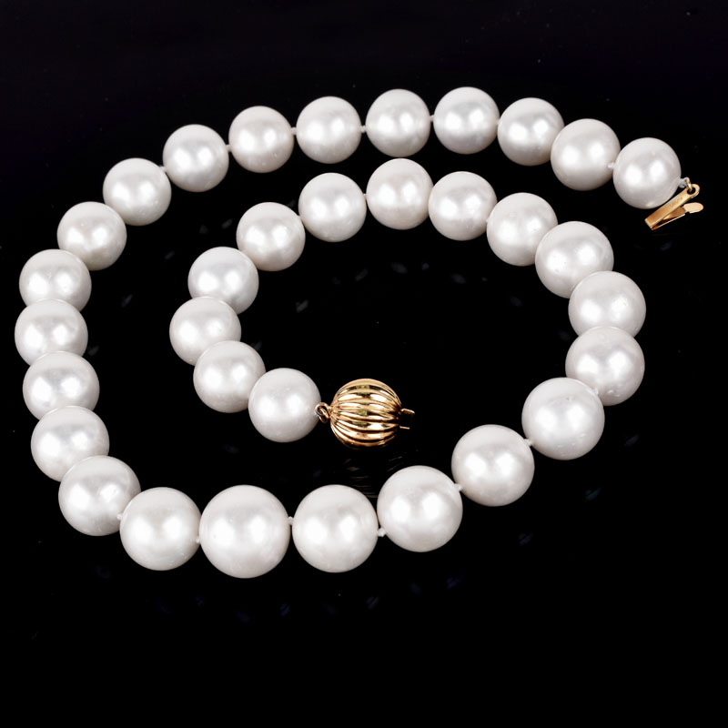 Single Strand Thirty Three (33) 13-15mm South Sea Pearl Necklace with 14 Karat Yellow Gold Clasp.