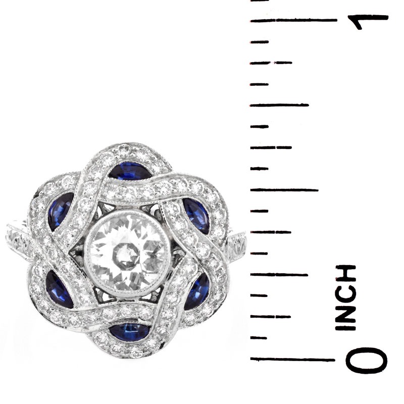 Art Deco style Diamond, Sapphire and Platinum Ring set in the Center with .66 Carat Round Brilliant Cut Diamond.