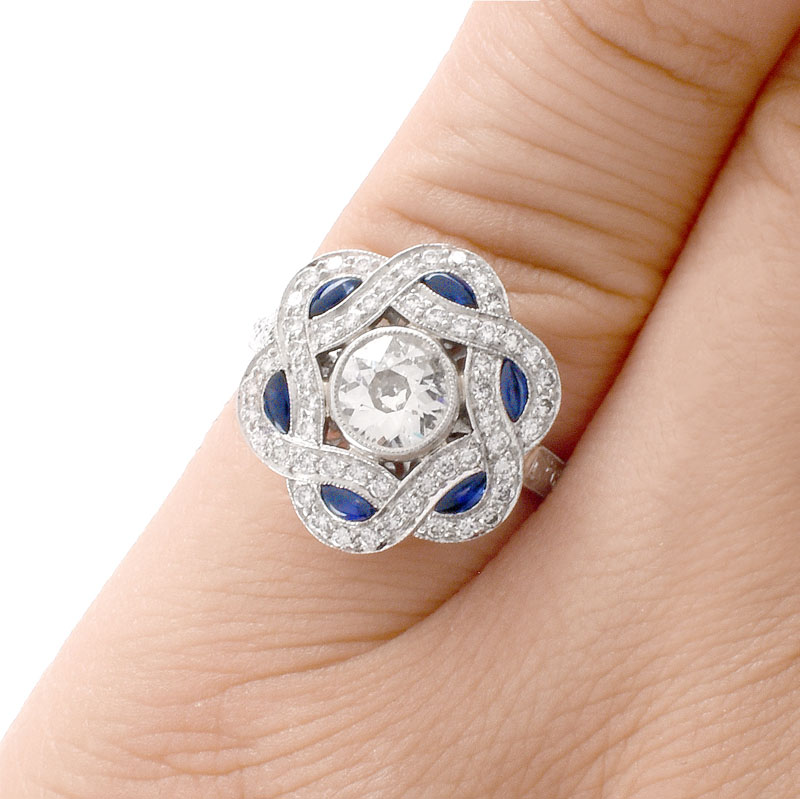 Art Deco style Diamond, Sapphire and Platinum Ring set in the Center with .66 Carat Round Brilliant Cut Diamond.