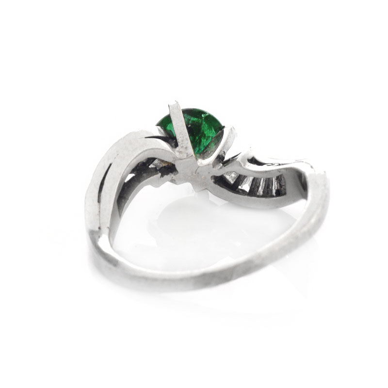 Vintage Circa 1940s Approx. 1.60 Carat Colombian Round Cut Emerald, 1.0 Carat Baguette Cut Diamond and Platinum Ring. Emerald with vivid color.