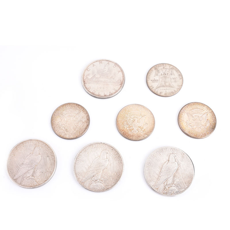 Collection of Eight (8) Silver Coins Including Three (3) Morgan Head Silver Dollars, Three (3) Kennedy Half Dollars, One Franklin Half Dollar and a Canadian Elizabeth II Dollar.