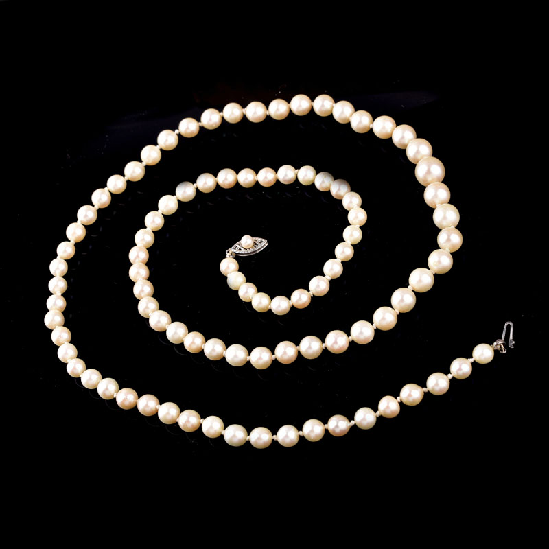 Antique Single Strand Ninety One (91) Graduated White Pearl Necklace with 14 Karat White Gold Clasp.