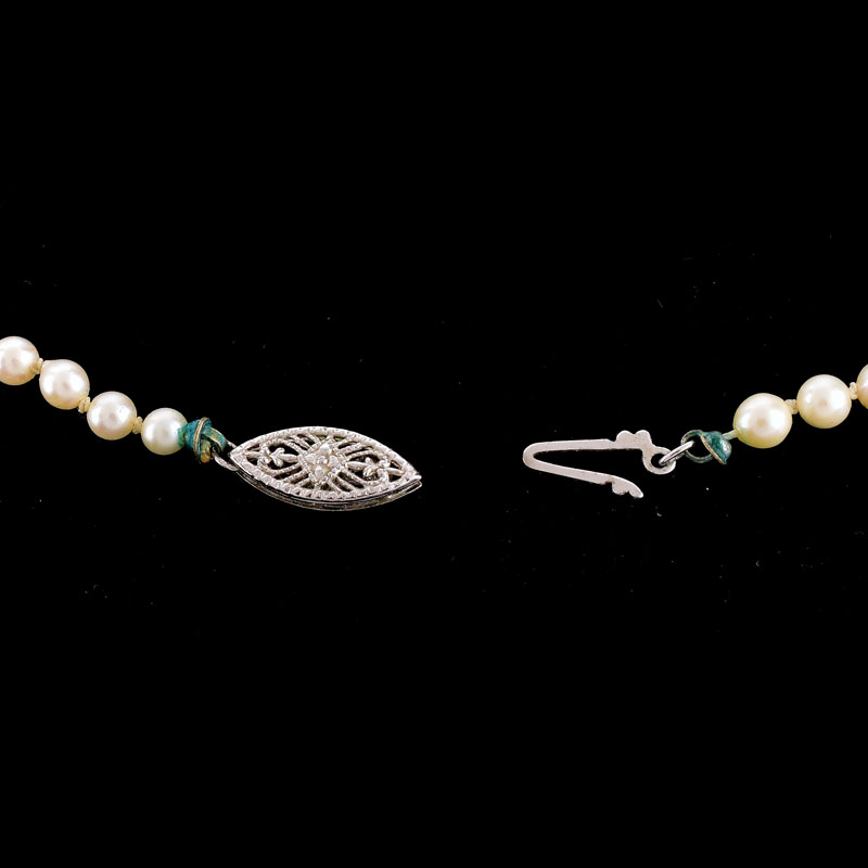 Antique Single Strand One Hundred Ninety Seven (197) Graduated White Pearl Necklace with 14 Karat White Gold Clasp.