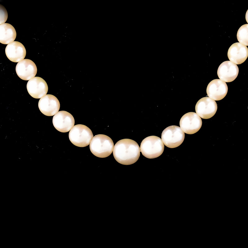 Antique Single Strand One Hundred Six (106) Graduated White Pearl Necklace with 14 Karat White Gold Clasp.