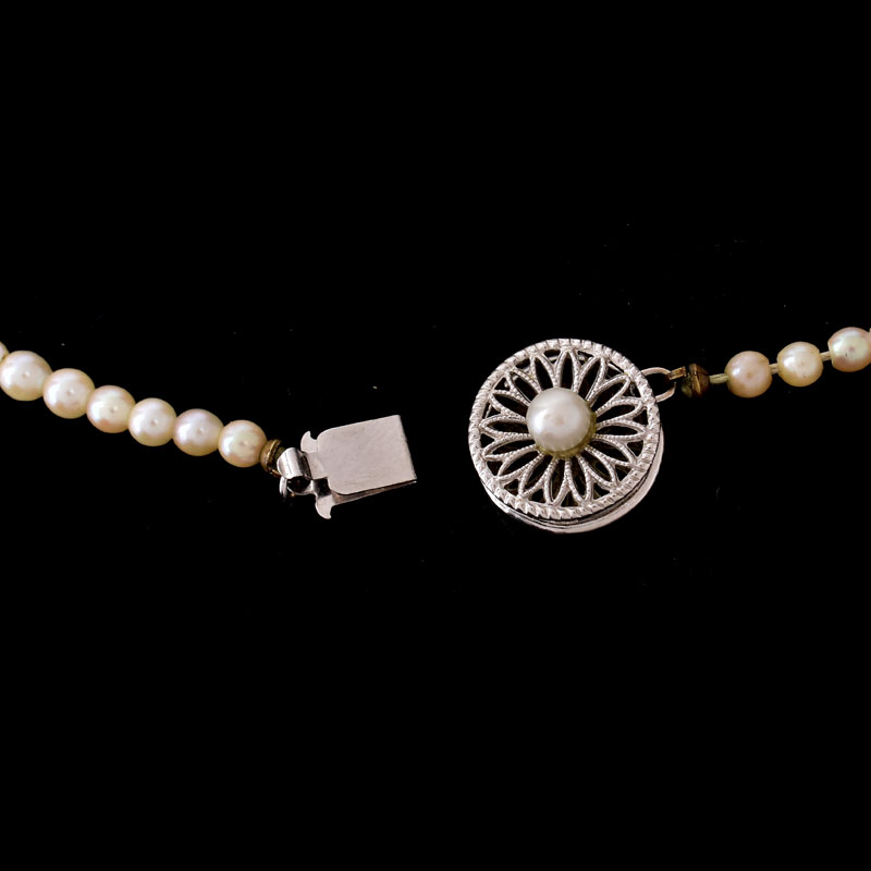 Antique Single Strand One Hundred Six (106) Graduated White Pearl Necklace with 14 Karat White Gold Clasp.
