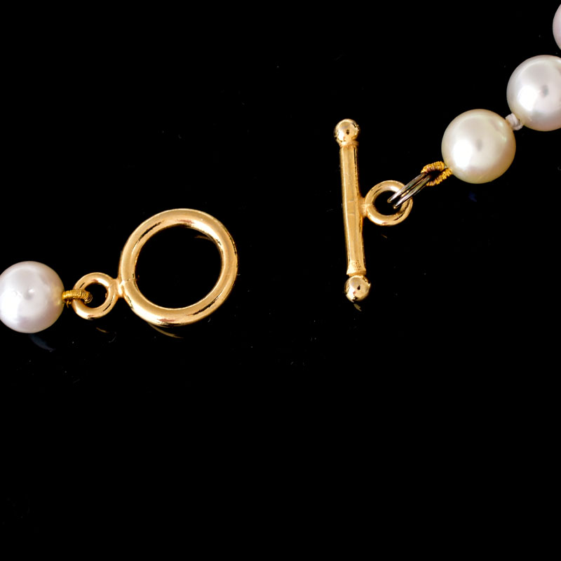 Vintage Single Strand Pearl Necklace with Gold Filled Clasp. Pearls measure 7mm each. Unsigned.