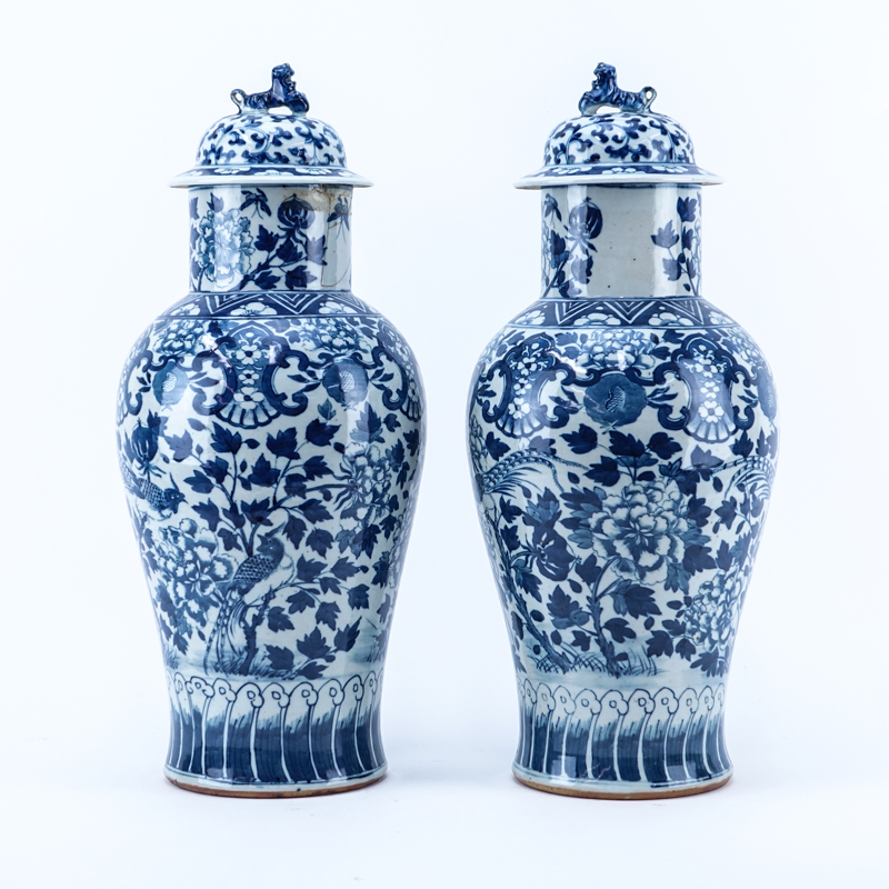 Pair of Mid Century Chinese Blue and White Porcelain Covered Urns with Foo Dog Finial.