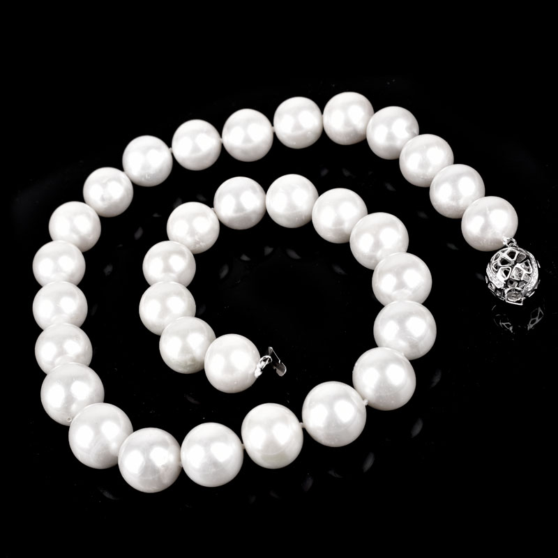 Single Strand Thirty Three (32) 12-14mm South Sea Pearl Necklace with 14 Karat White Gold and Diamond Clasp.