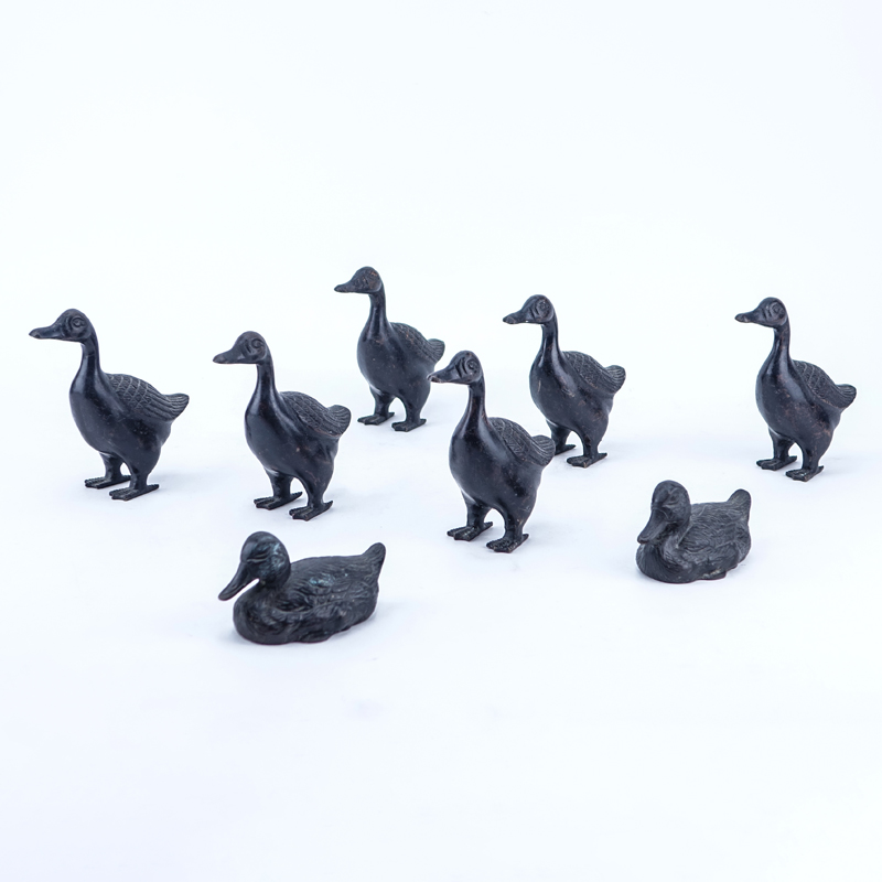 Lot of Eight (8) Patinated Bronze Duck Figures.
