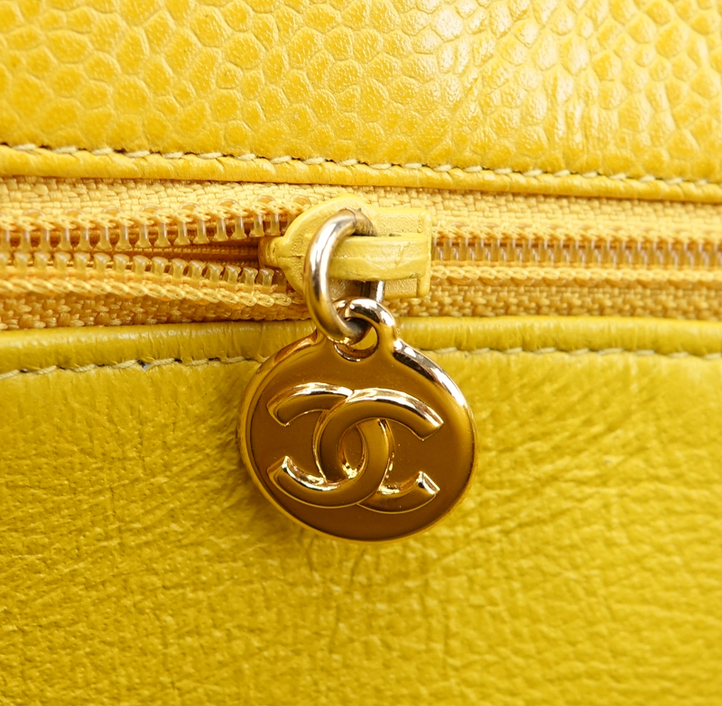 Chanel Yellow Caviar Leather Vintage Tote With Front Logo. Gold tone hardware. Interior with large zipper pocket.