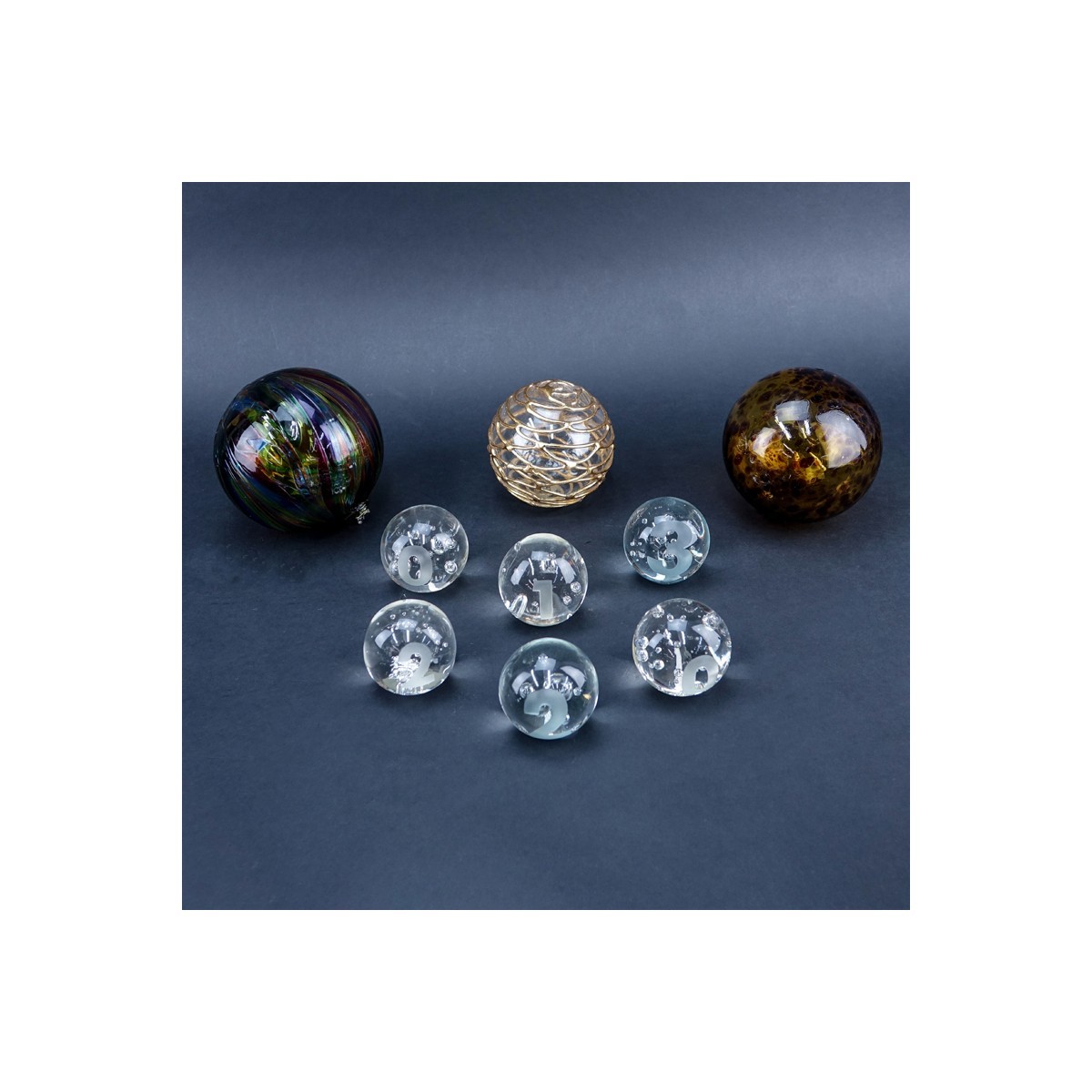 Group of Nine (9): Six Vintage Glass Paperweights along with Three Art Glass Spheres. Label attached to a few paperweights, spheres are unsigned.