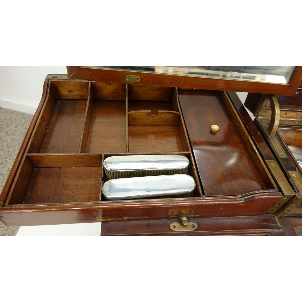 Attributed to: George Betjeman & Sons Circa 1910 Edwardian Mahogany Enclosed Dressing Table. The rectangular hinged top enclosing an interior fitted with three beveled mirror plates, above two hinged compartments flanked by two glass slides and a recessed