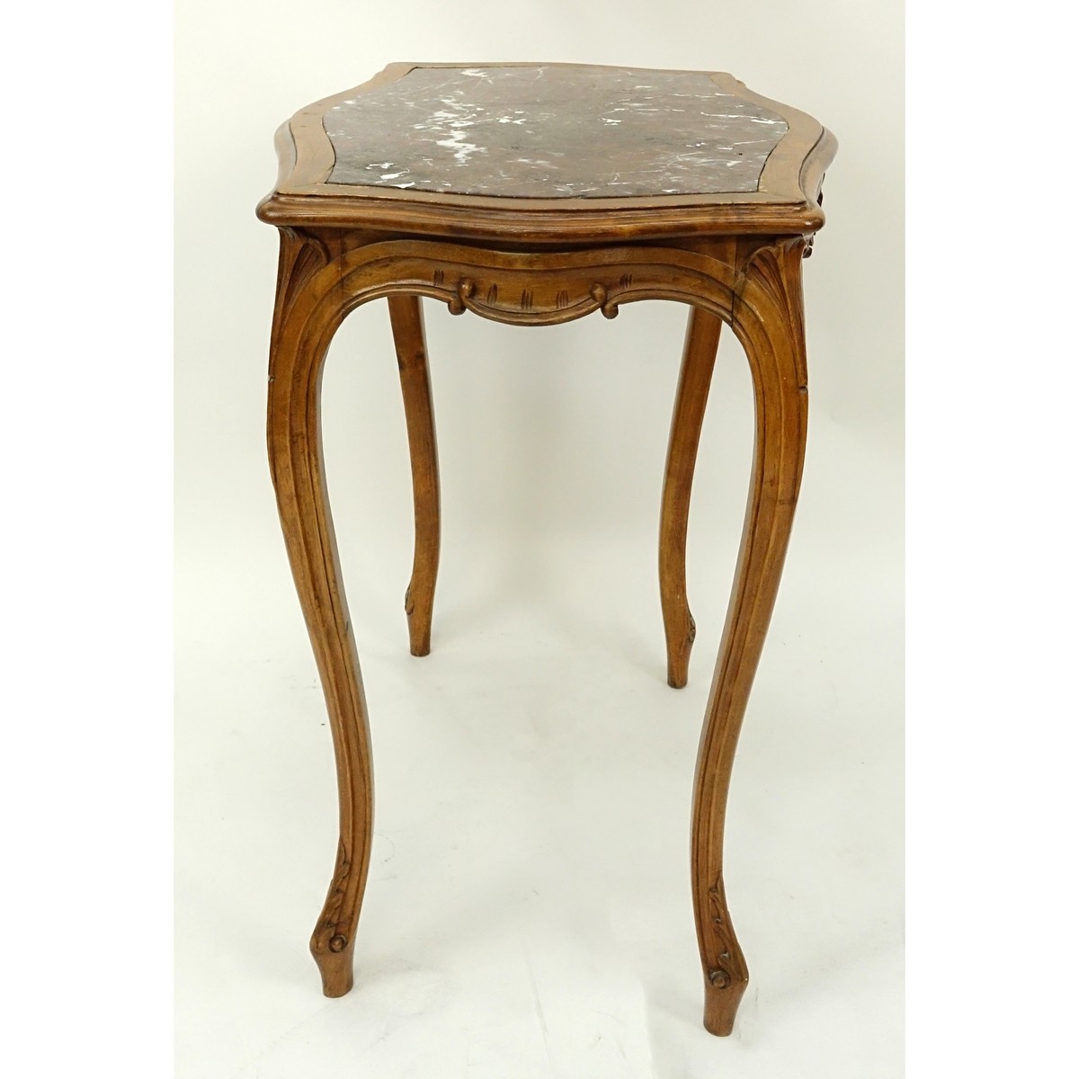 19/20th Century French Carved Wood Table with Marble Top. Carved apron with high cabriole legs.