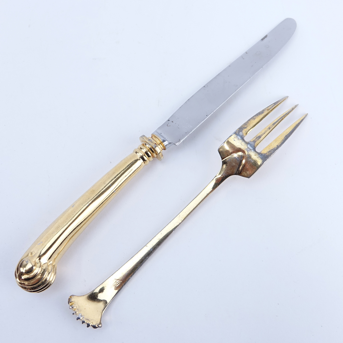 Ninety Eight (98) Pieces Oxford House Gold Plated Stainless Flatware. Set includes: 12 forks 7-1/4", 17 knives 9-1/2", 16 salad forks, 7 soup spoons, 9 teaspoons, 12 cocktail forks, 20 butter paddles, meat fork, slotted spoon, pie server, 2 serving spoons