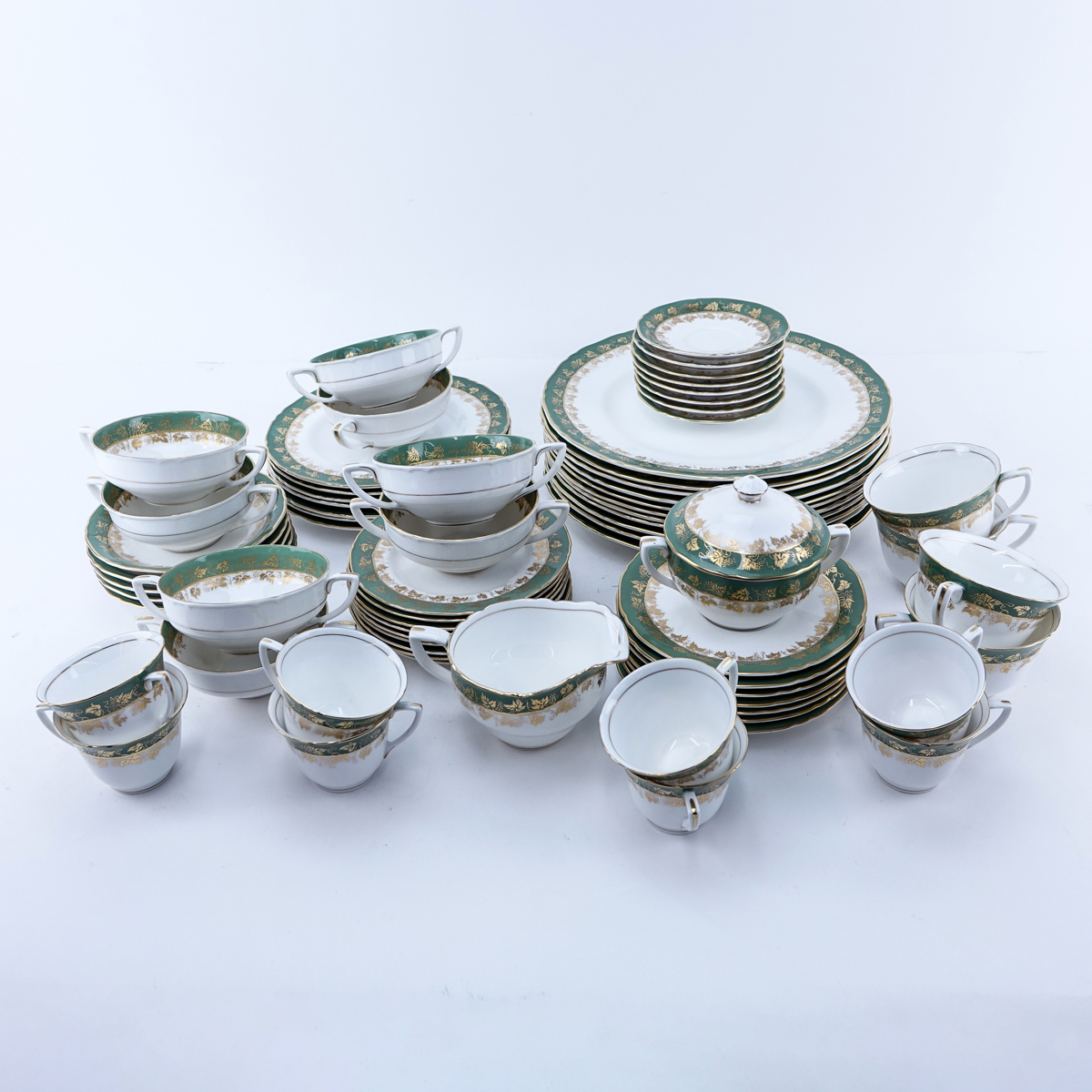 Sixty Nine (69) Piece Royal Worcester Arundel Green Partial Dinnerware Set. Includes: 11 dinner plates 10-3/4", 7 salad plates, 8 handled soup cups, 7 saucers, 4 cups, 5 saucers, 8 demitasse cups, 8 saucers, 9 bread and butter plates, creamer and sugar bo