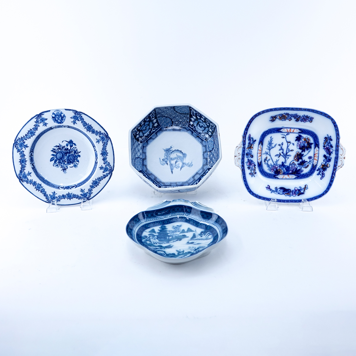 Four Pieces Blue & White Pottery Decorative Table Top Items. Includes a Mottahedeh Chinese motif dish, a flow blue platter, a Chinese bowl and an unsigned dish.