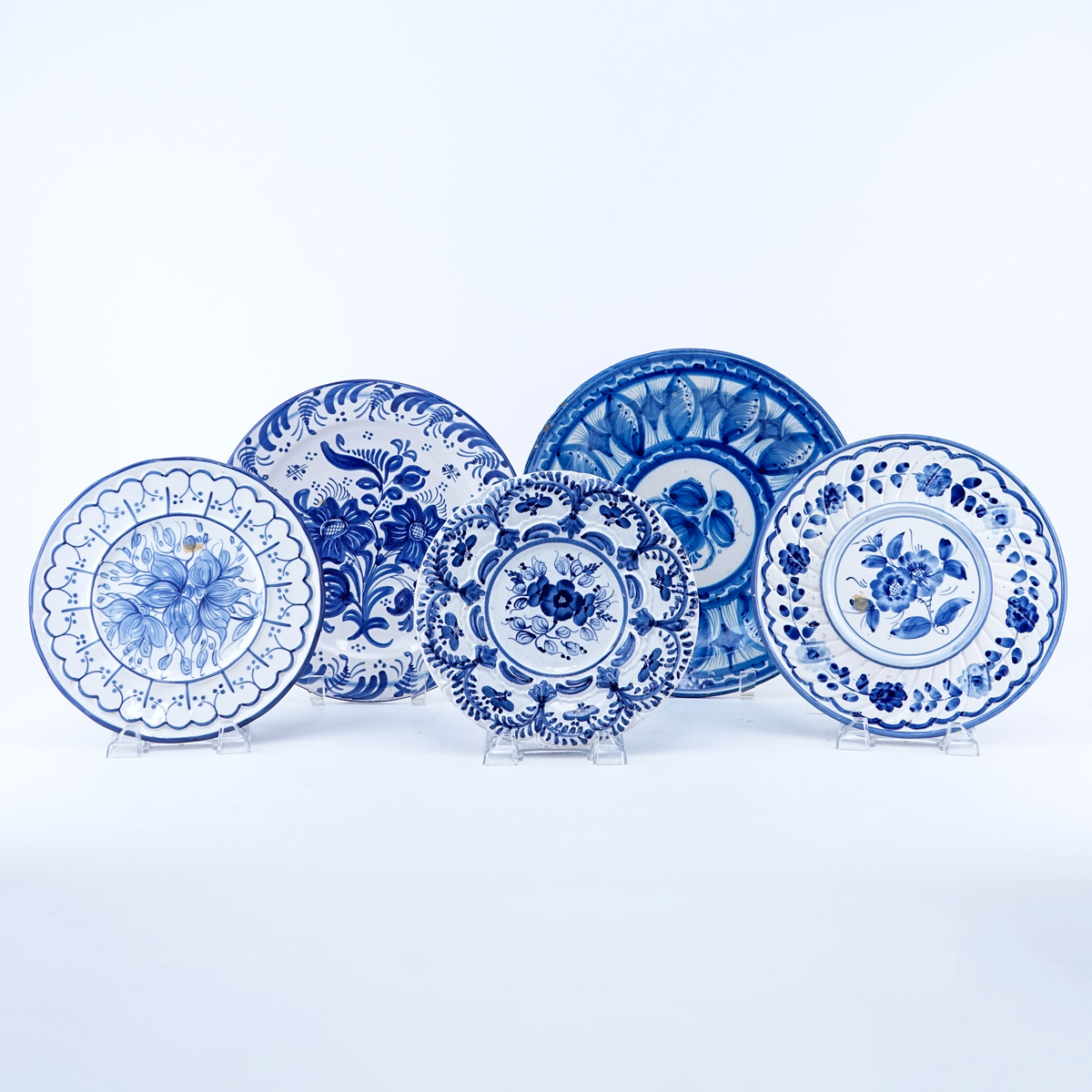 Lot of Five (5) Blue & White Decorative Pottery Plates. Various signatures.