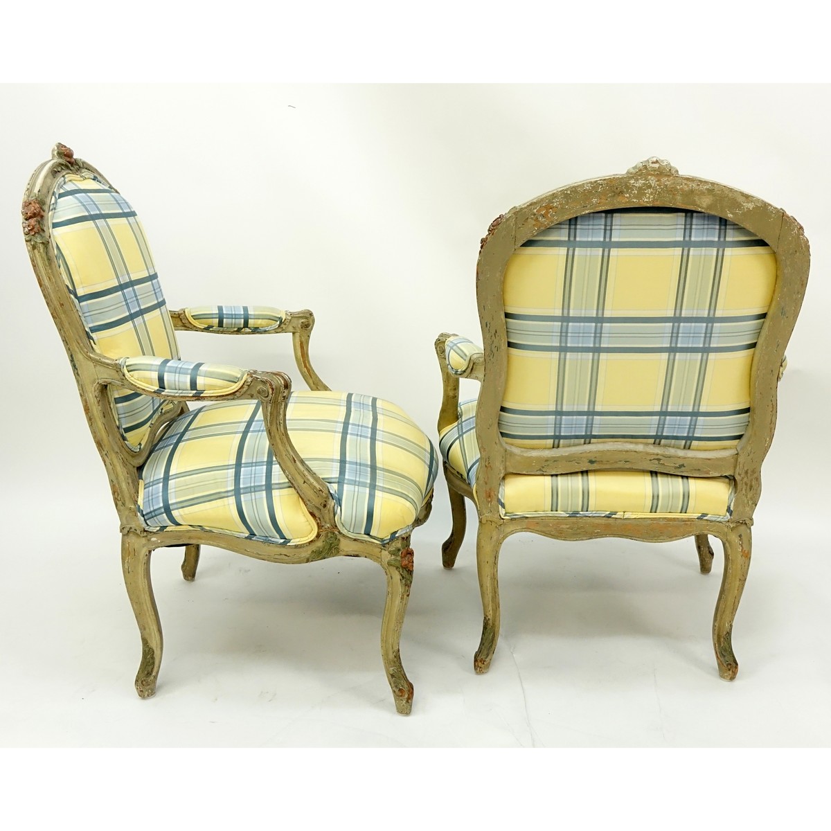 Pair of 18/19th Century French Carved Wood and Upholstered Fauteuils. Painted floral accents to frame, stands on cabriole legs.