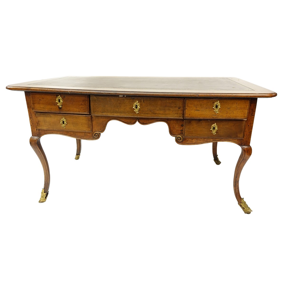 Large 19th Century French Walnut Writing Desk with Tooled Leather Top, Gilt Bronze Mounts. Large center drawer flanked by four fitted drawers, stands on tapering cabriole legs with hooves as feet.