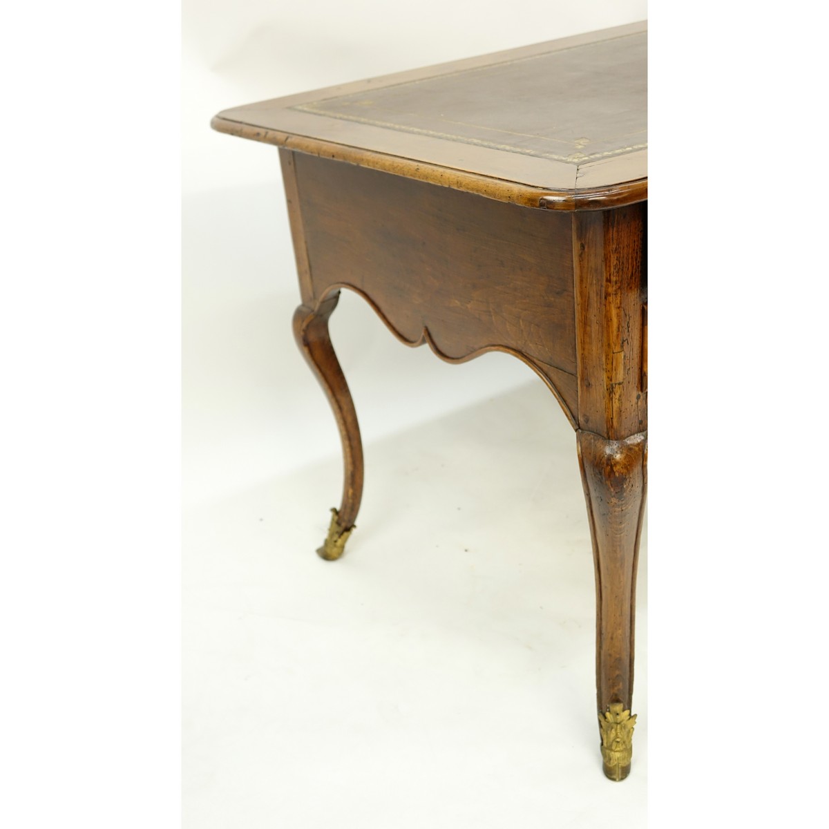 Large 19th Century French Walnut Writing Desk with Tooled Leather Top, Gilt Bronze Mounts. Large center drawer flanked by four fitted drawers, stands on tapering cabriole legs with hooves as feet.