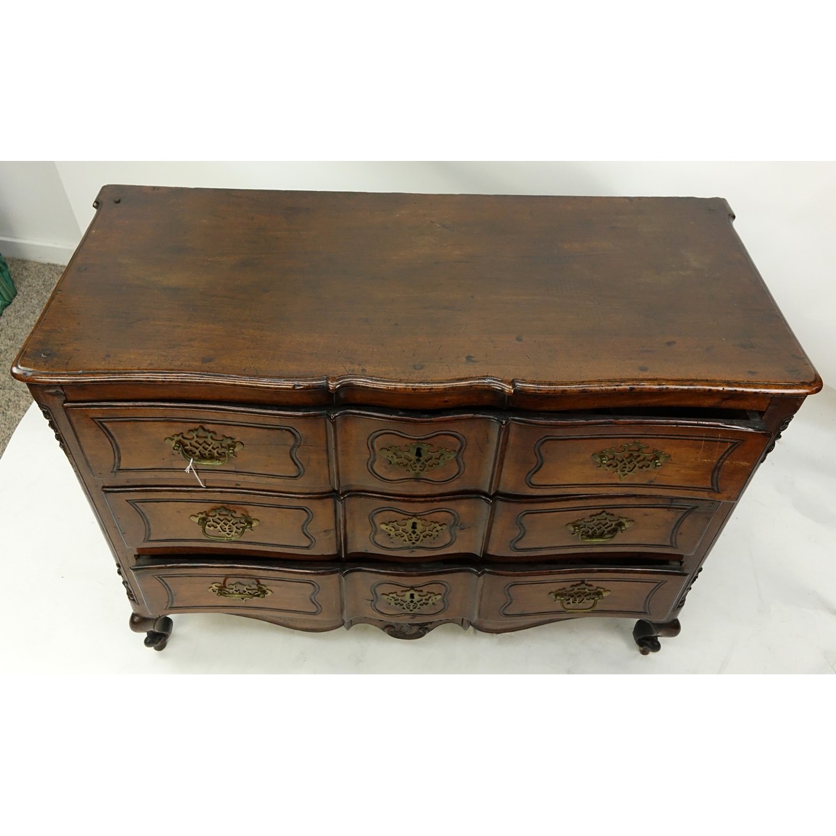 19th Century French Carved Walnut Commode/Chest of Drawers with Bronze Pulls. Three large fitted drawers and stands on front cabriole and rear bracket legs.
