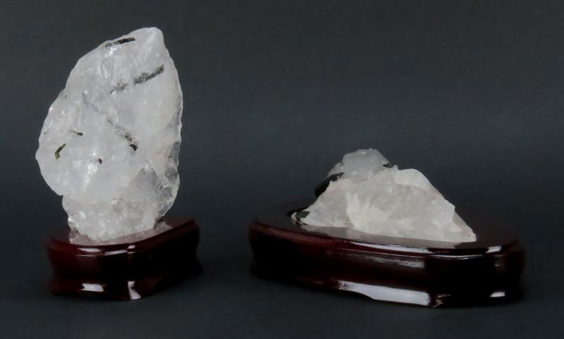 Two (2) Rock Crystal Mineral Specimen on Wooden Stands. Both are lightly smoky with black structures.