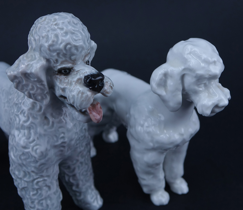 Two Porcelain Poodle Figurines. One signed with Meissen mark, one with Rosenthal mark.
