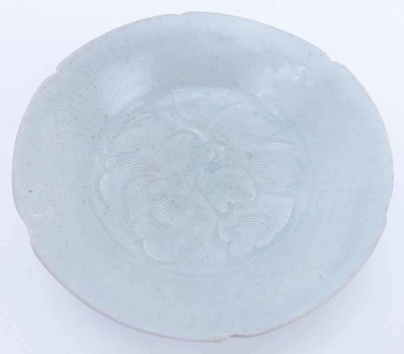 Chinese Song Dynasty (1127–1279) Oingbai Ware Dish. A lobed dish with a central combed peony blossom filling the well covered with pale bluish-green glaze.