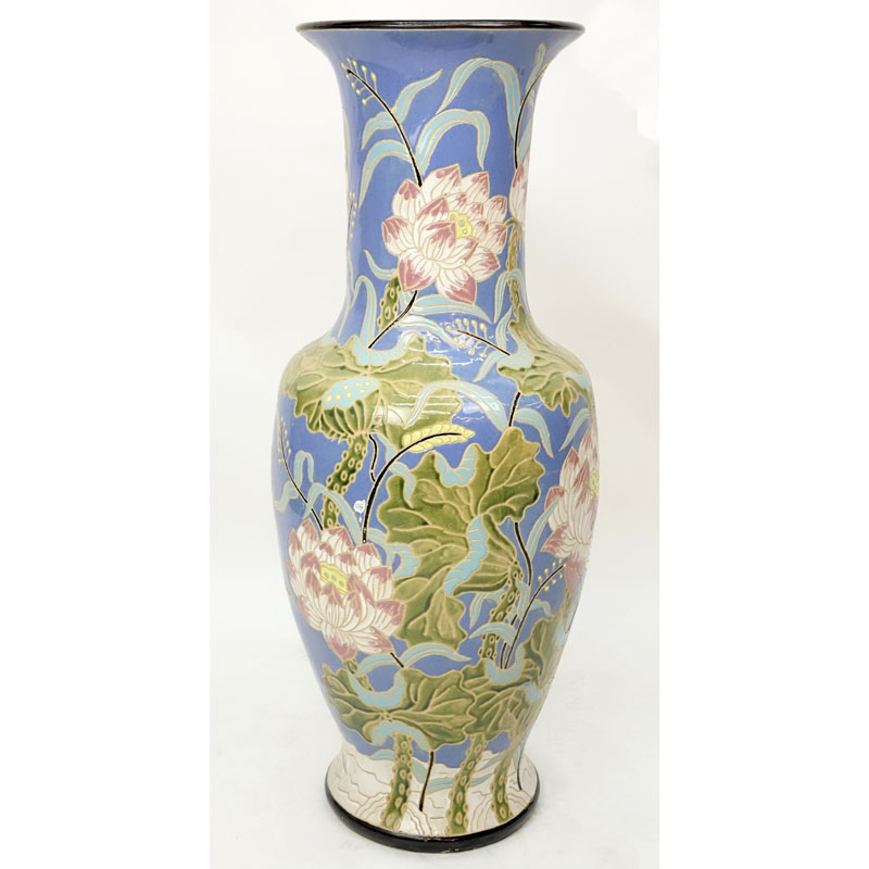Monumental Majolica Pottery Vase. Features Asian inspired lotus flower motif on blue ground.