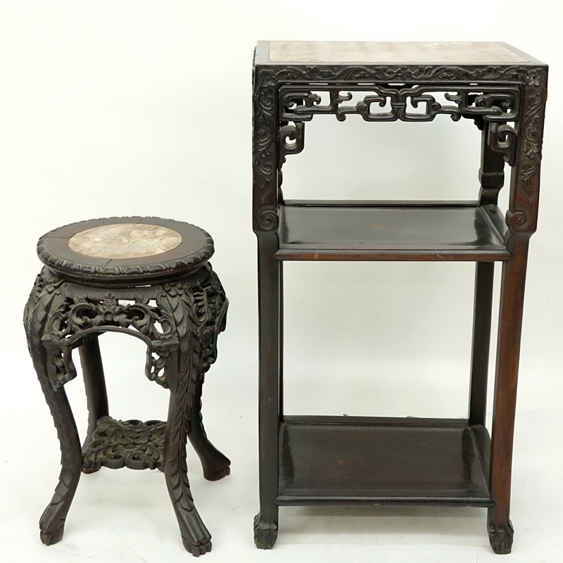 Two (2) Chinese Carved Rosewood and Marble Top Stands. Large stand has old wood worm damage to a portion of one leg but does not appear to be active, both stands have scratches, splits, and nicks.