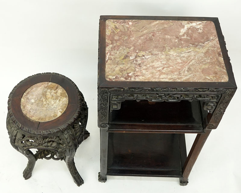 Two (2) Chinese Carved Rosewood and Marble Top Stands. Large stand has old wood worm damage to a portion of one leg but does not appear to be active, both stands have scratches, splits, and nicks.