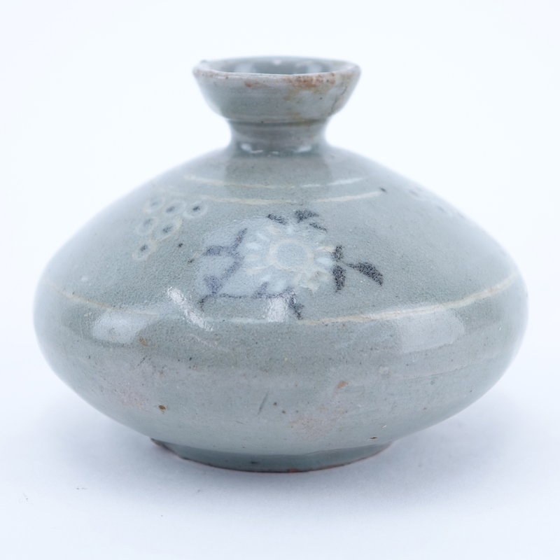 Chinese Goryeo Dynasty, 12th - 14th Century Celadon Glazed Oil Bottle. Inlaid around the shoulder in black and white slip with chrysanthemum sprigs alternating with pearl clusters.