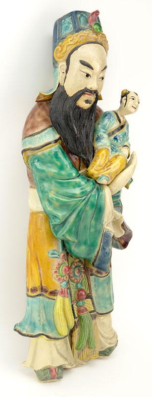 Chinese Polychrome Glazed Pottery of a Deity with Child. Crazing to glaze, typical cracks and nicks.