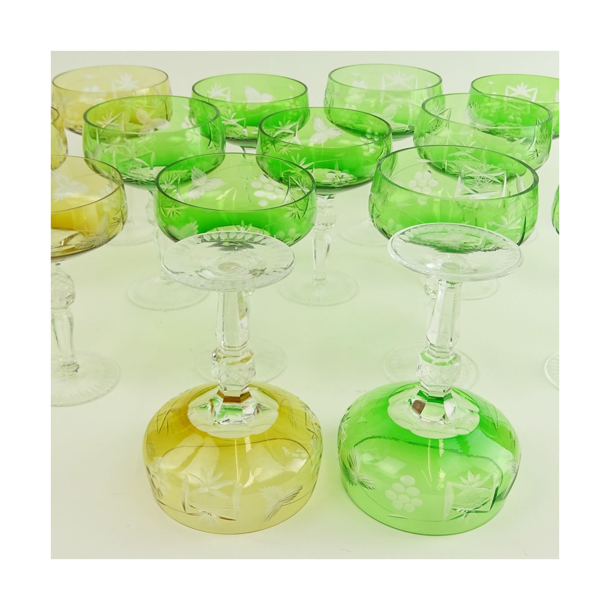 Lot of 17 Bohemian Cut Glass Champagne Coupes in Green (12) and Amber (5). Measure 5-5/8". Very goo
