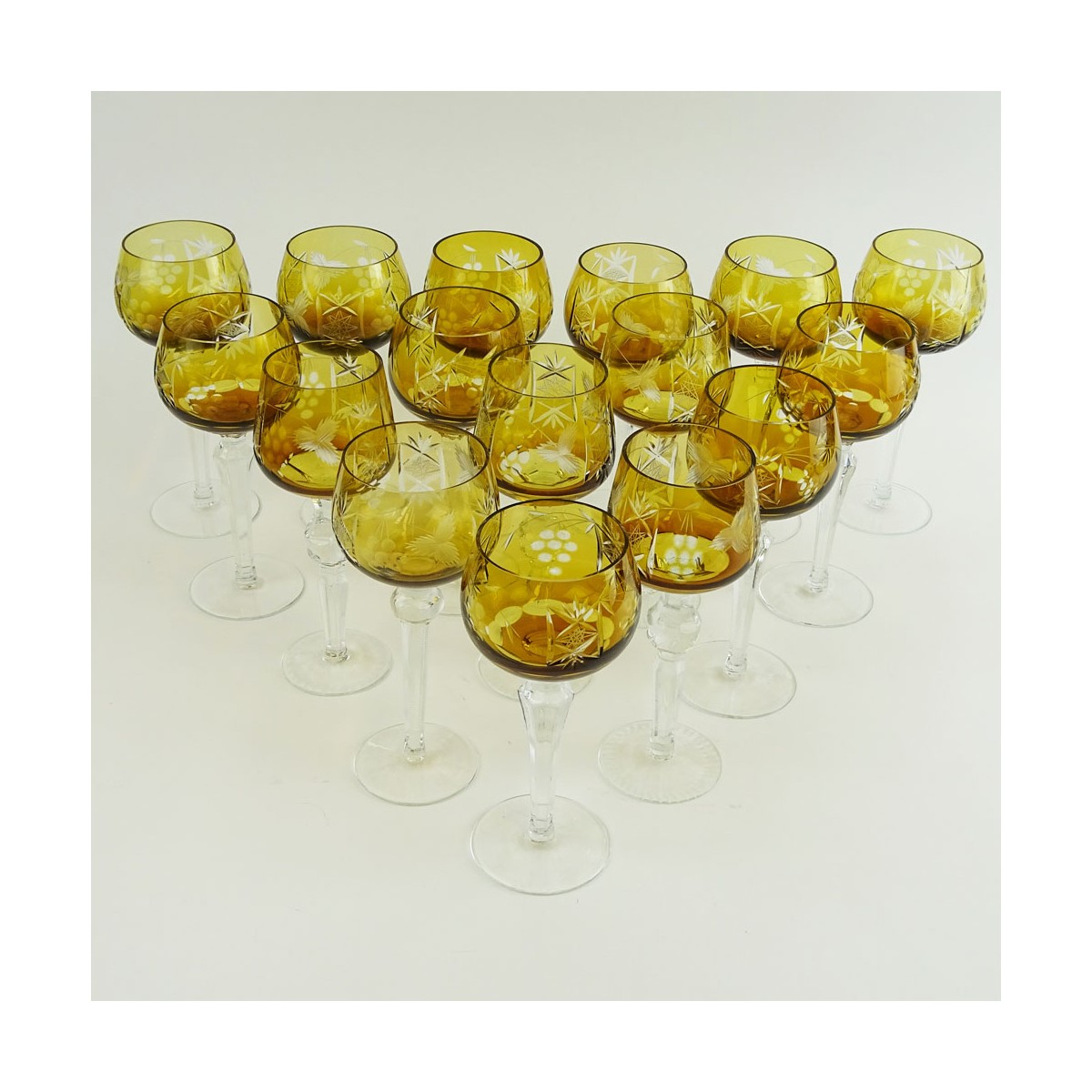 Lot of 16 Bohemian Cut Glass Wine Hocks in Amber. Various stems. Measures 8" to 8-1/4". Very good c