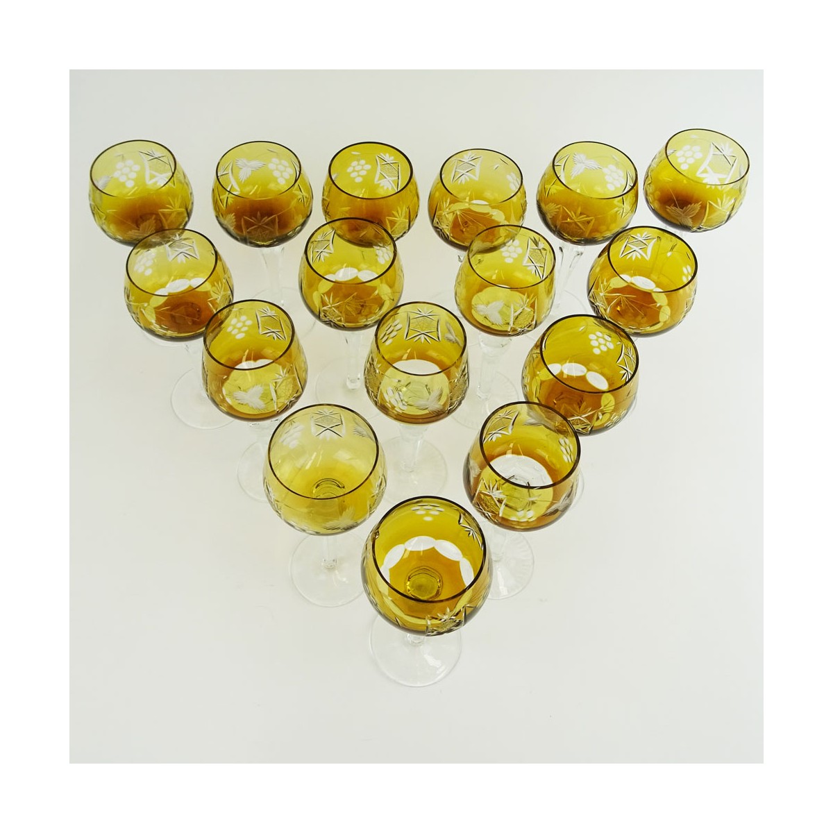 Lot of 16 Bohemian Cut Glass Wine Hocks in Amber. Various stems. Measures 8" to 8-1/4". Very good c