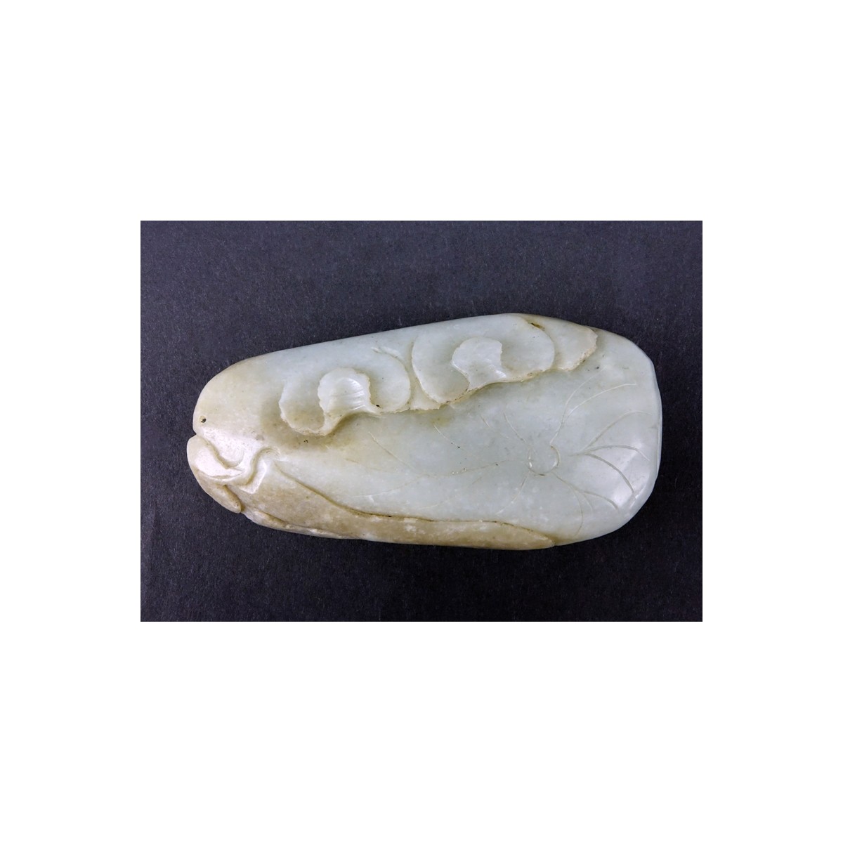 19/20th Century Chinese Carved Jade Pendant. Natural wear. Measures 4" H x 2" W.  (estimate $50-$10