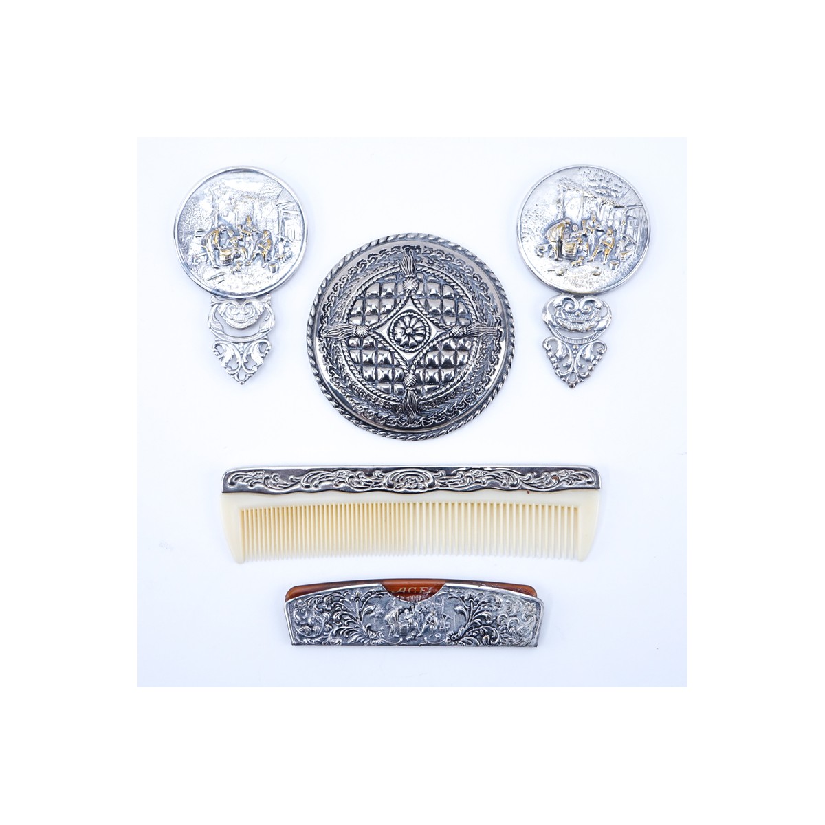 Collection of Five (5) Repousse Silver Plated Vanity Items. Includes: two combs and three mirrors.