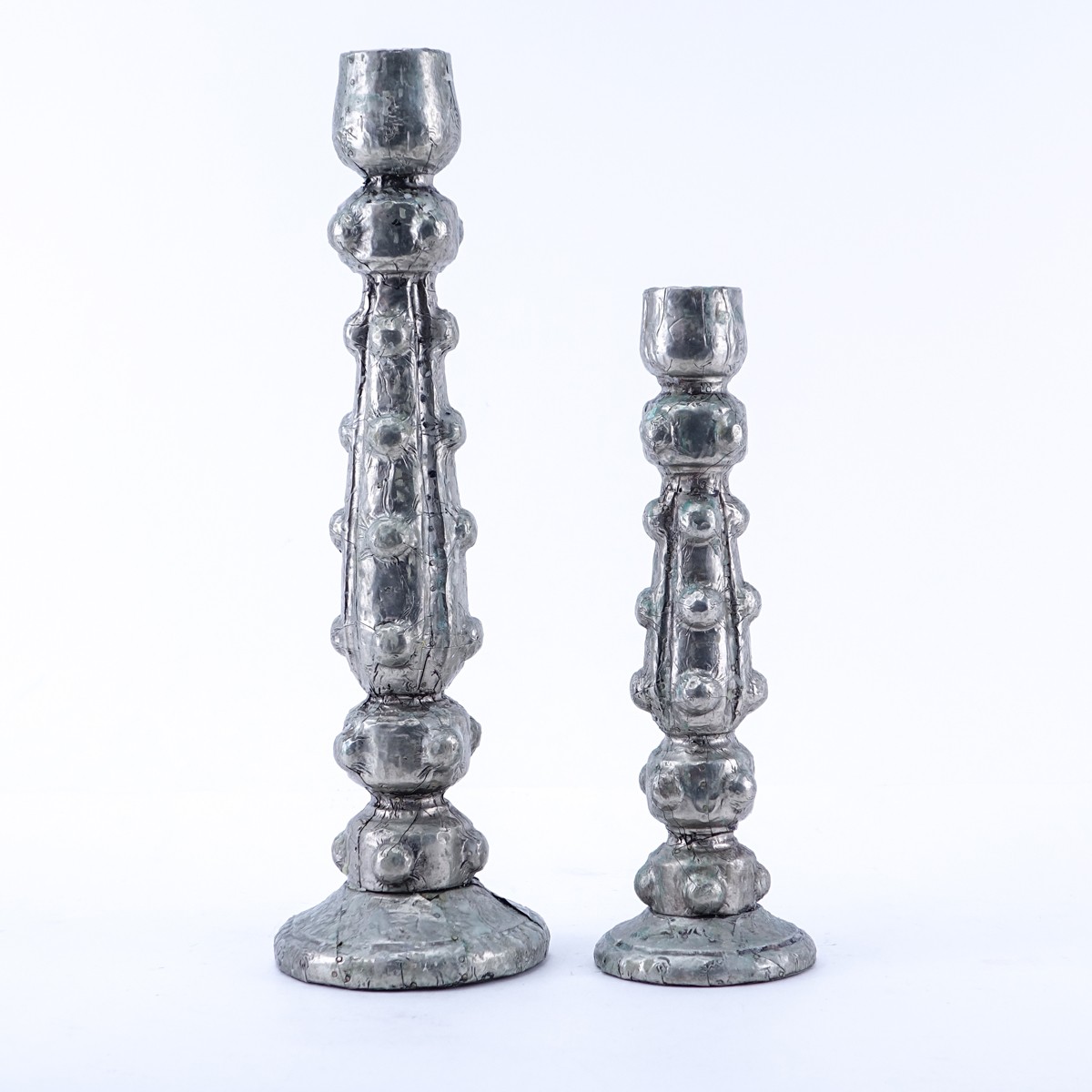 Two (2) Foil Clad Candlesticks. Unsigned. Wax residue. Measures 16" H & 12" H.  (estimate $25-$50) 