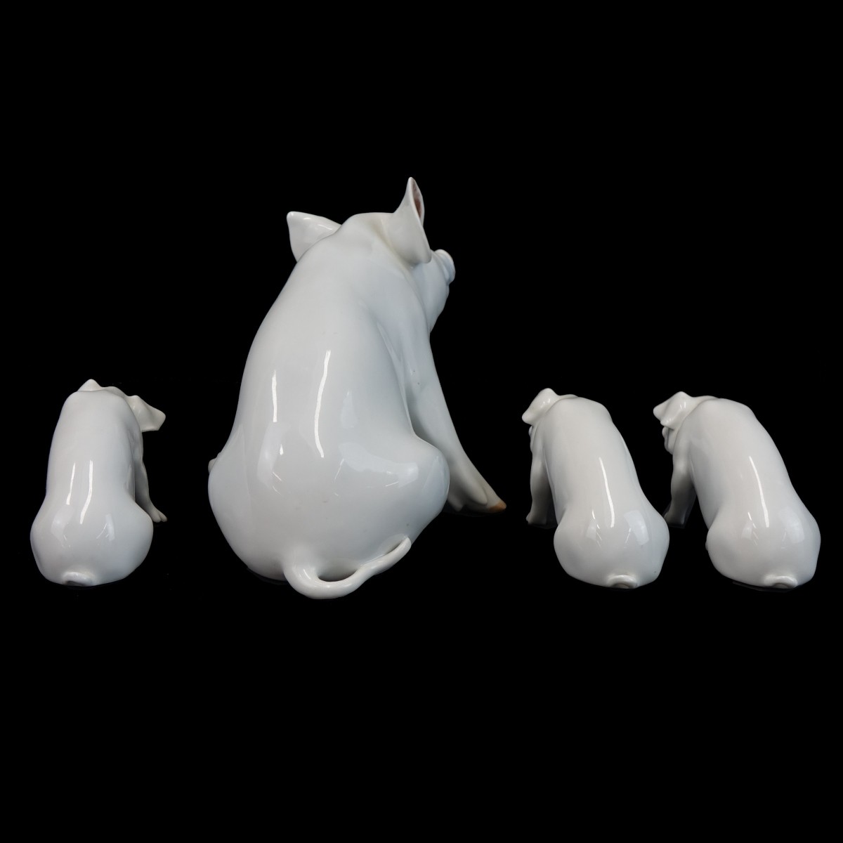 Four (4) Royal Copenhagen Porcelain Pig Figurines