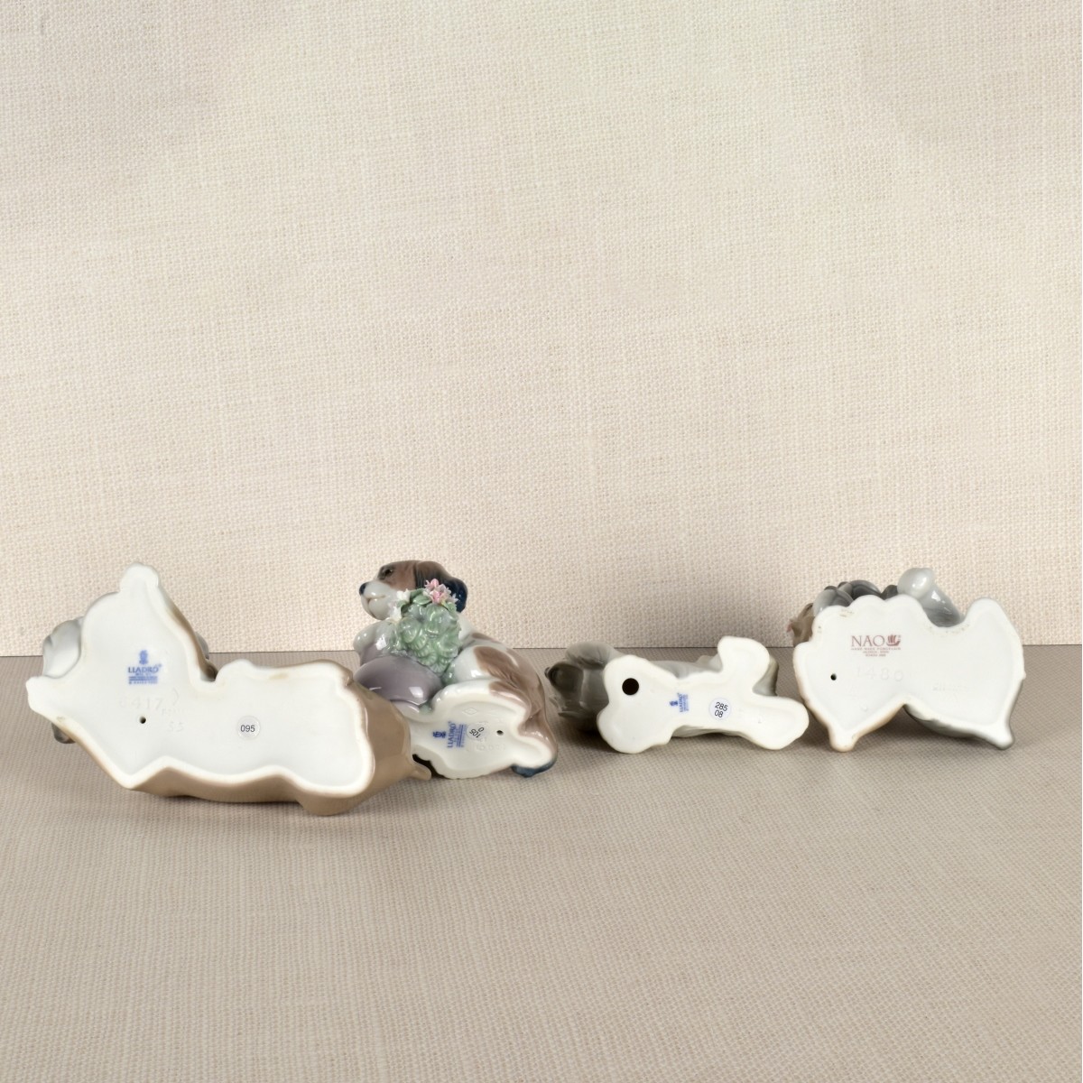Four Lladro Porcelain Dog Figurines