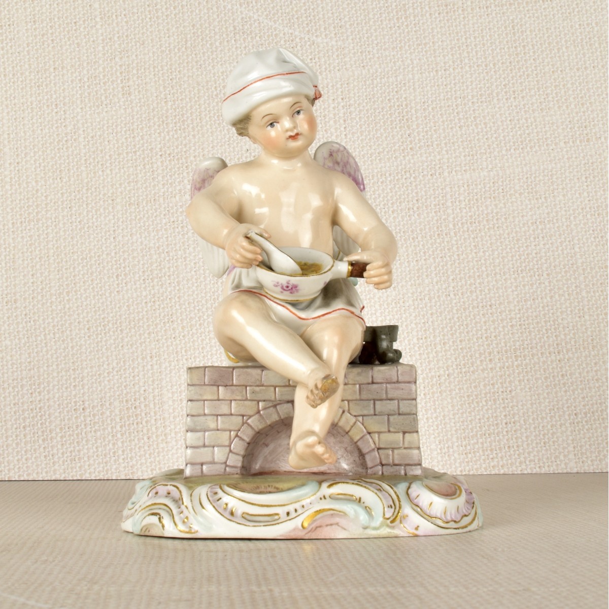 Meissen Figurine of a Winged Child Cooking