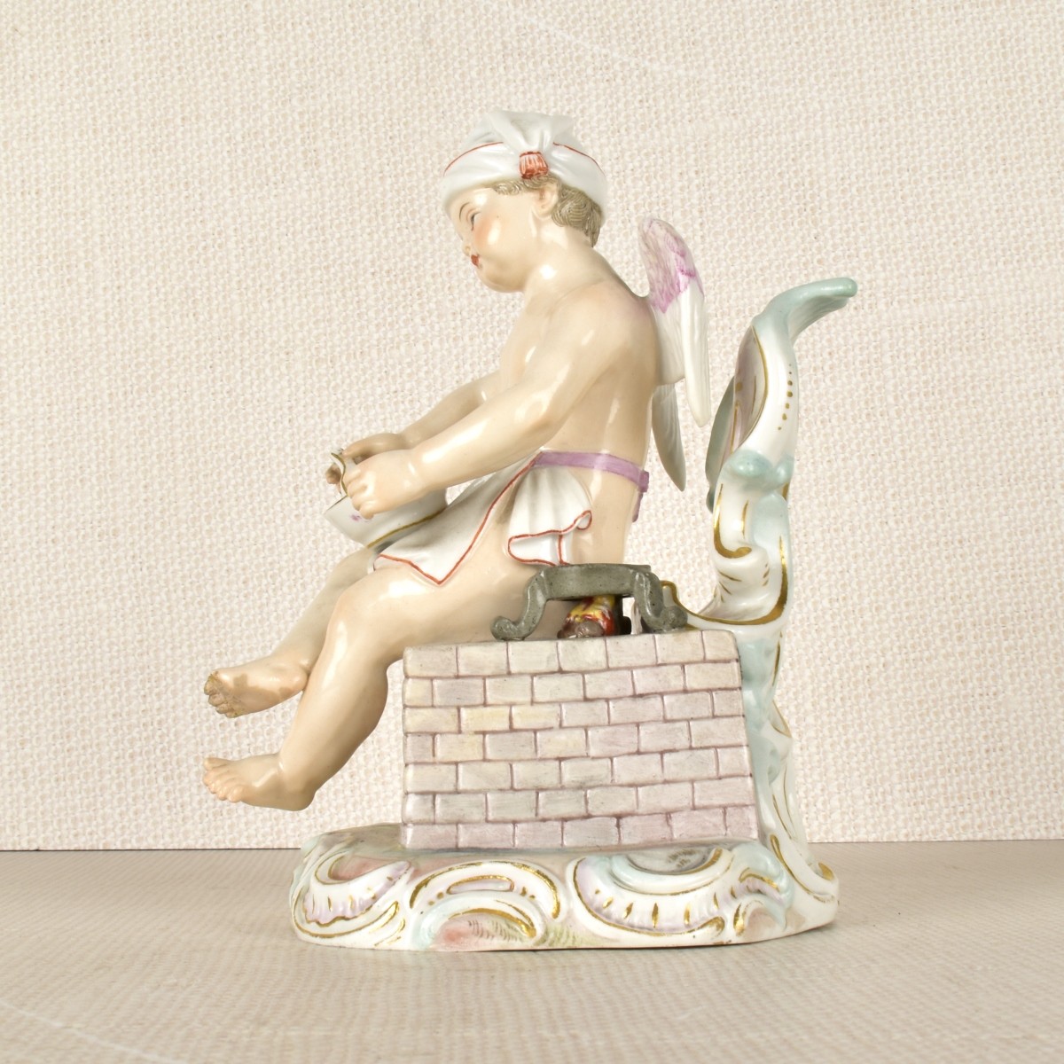 Meissen Figurine of a Winged Child Cooking