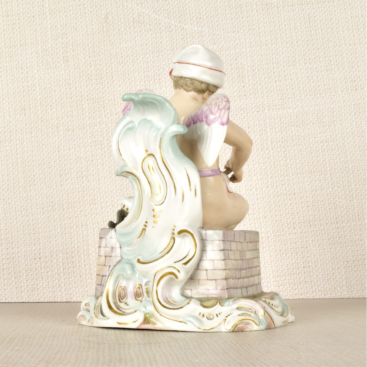 Meissen Figurine of a Winged Child Cooking