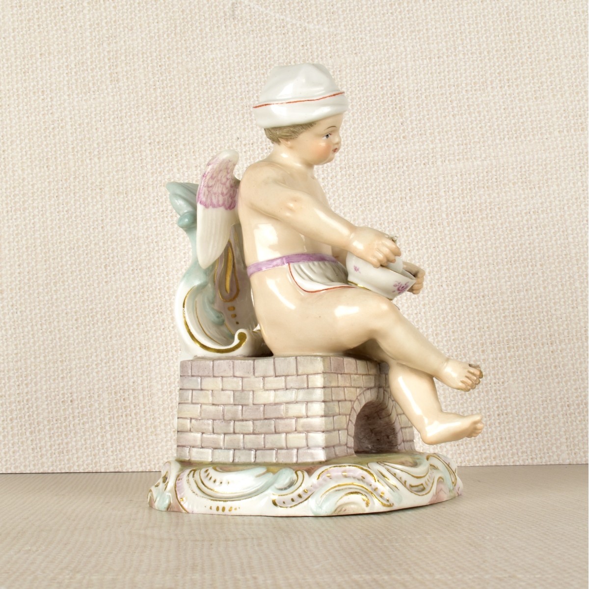 Meissen Figurine of a Winged Child Cooking