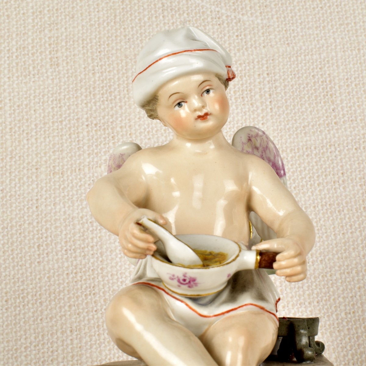 Meissen Figurine of a Winged Child Cooking